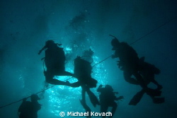 Divers on their way to the wreck of the Sea Emperor out o... by Michael Kovach 